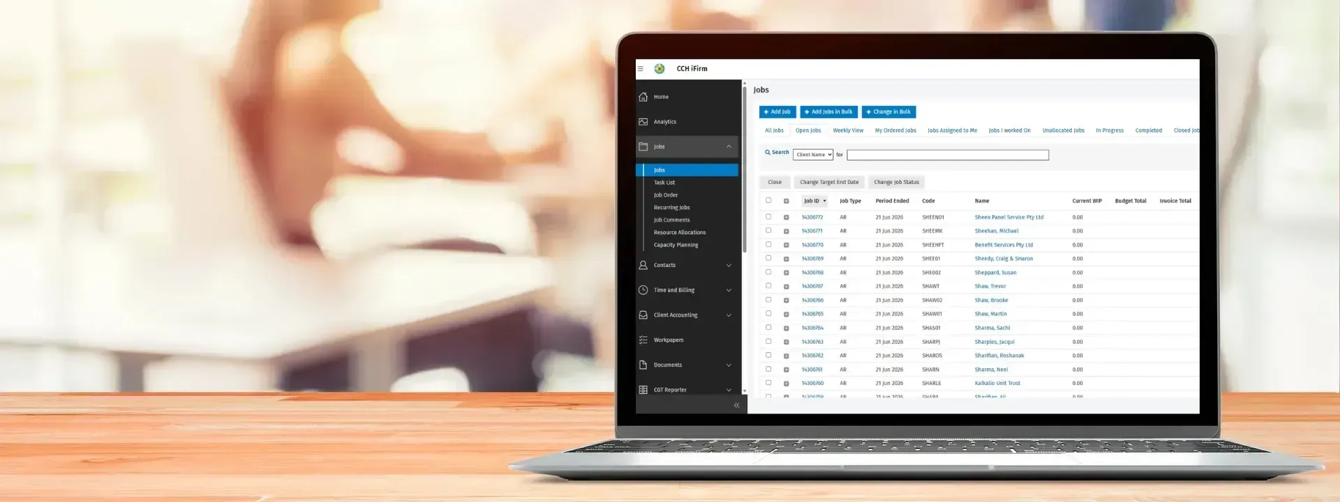 The cloud practice-management workspace on a laptop: a left navigation listing the areas of a firm's work: jobs, contacts, time and billing, client accounting, workpapers, documents, beside a job table with IDs, job types, period-end dates and client codes, filtered by job status.